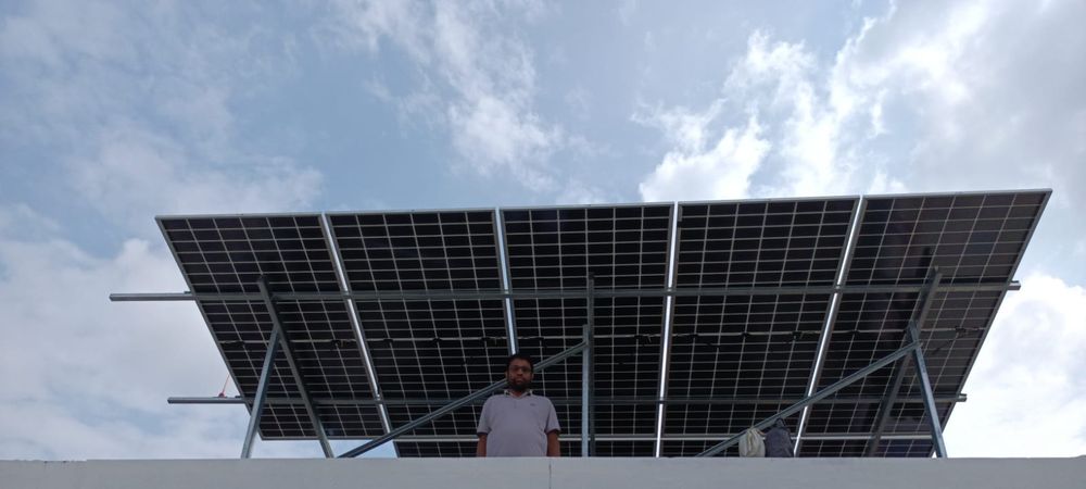 Wide view of an elevated rooftop solar panel array installed in Ashiyana Colony, Lucknow